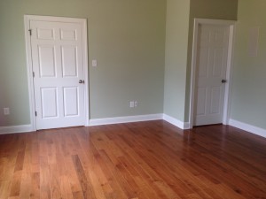 Protective cover removed from exercise room flooring.  Note that we opted for the white shoe molding.