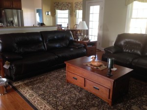 Family Room - love the storage in this coffee table and the fact that it's on wheels and can raise to fit right over us for snacks and martinis while lounging on the sofa.  Clearly, its the reason we need an exercise room.